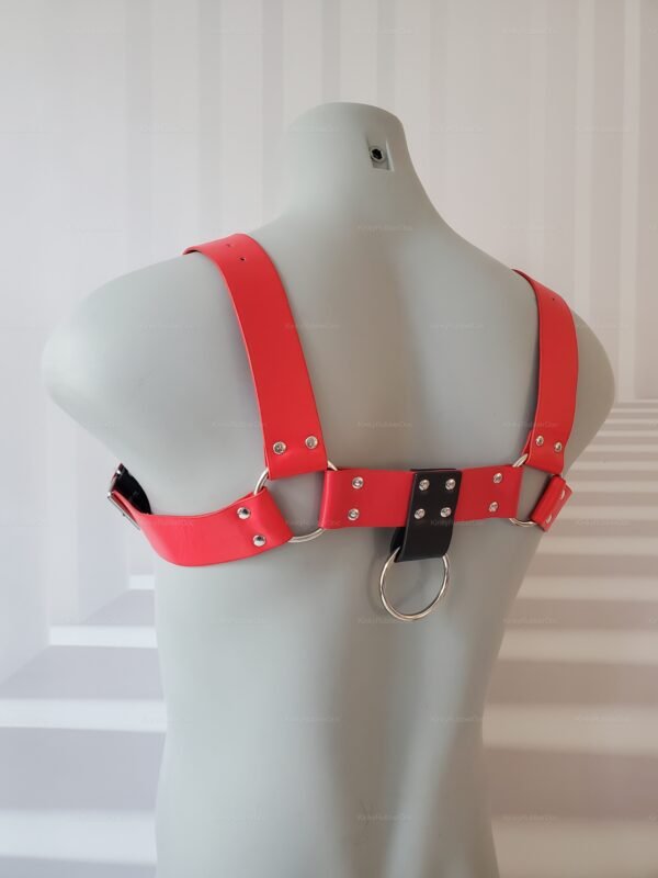 **Alt Text**: Unisex red and black leather-look harness with metal rings and rivets.