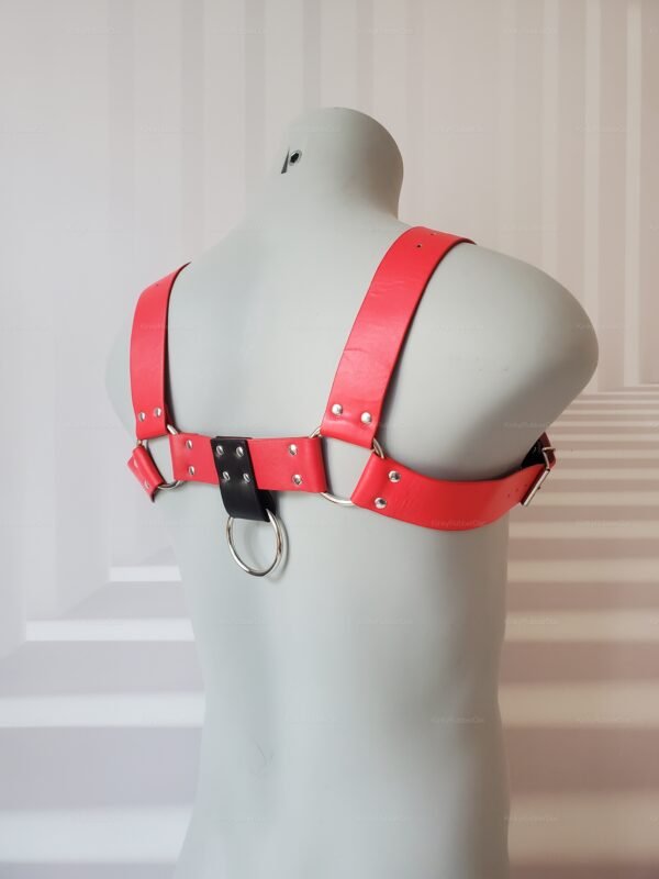 Red and black harness with D-ring detail for fetish wear.