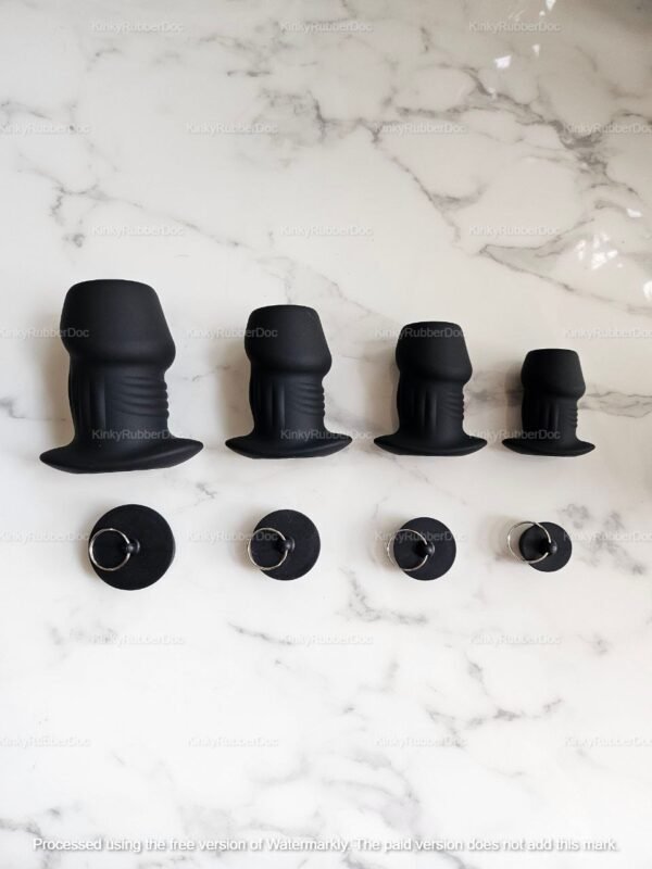 A Soft Hollow Silicone Plug Set in different sizes, featuring a textured surface and a secure ring handle, displayed on a marble background.