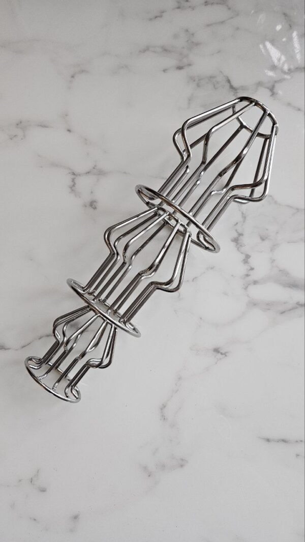 A stainless steel open-frame plug with a sleek, modern structure, displayed on a marble surface.