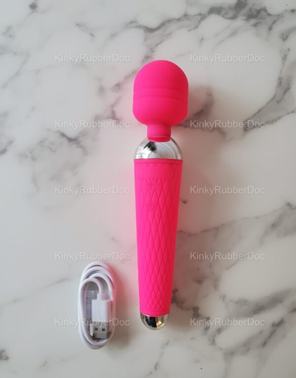 Bright pink USB wand vibrator with textured silicone grip and rounded silicone head, shown with white charging cable