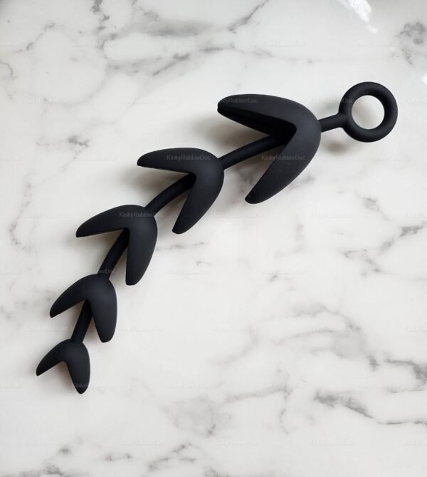 Black Deep Grip Silicone Claw Beads anal toy with spiked bead shape and pull ring on white marble background