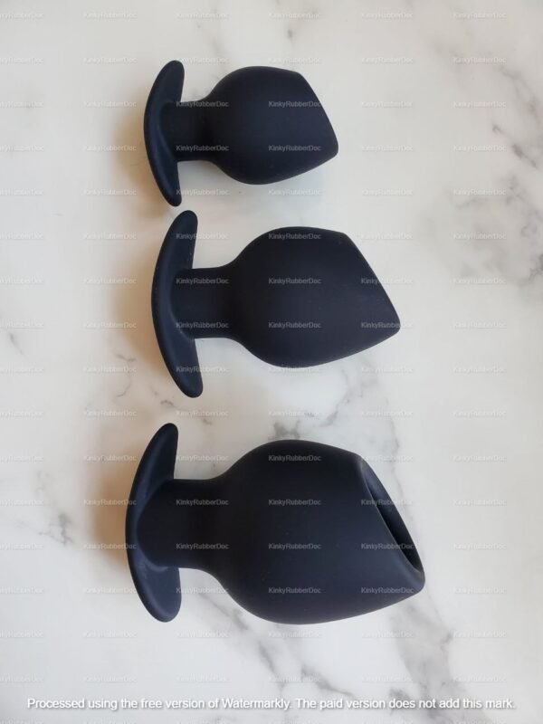 Set of three black hollow silicone butt plugs in varying sizes.