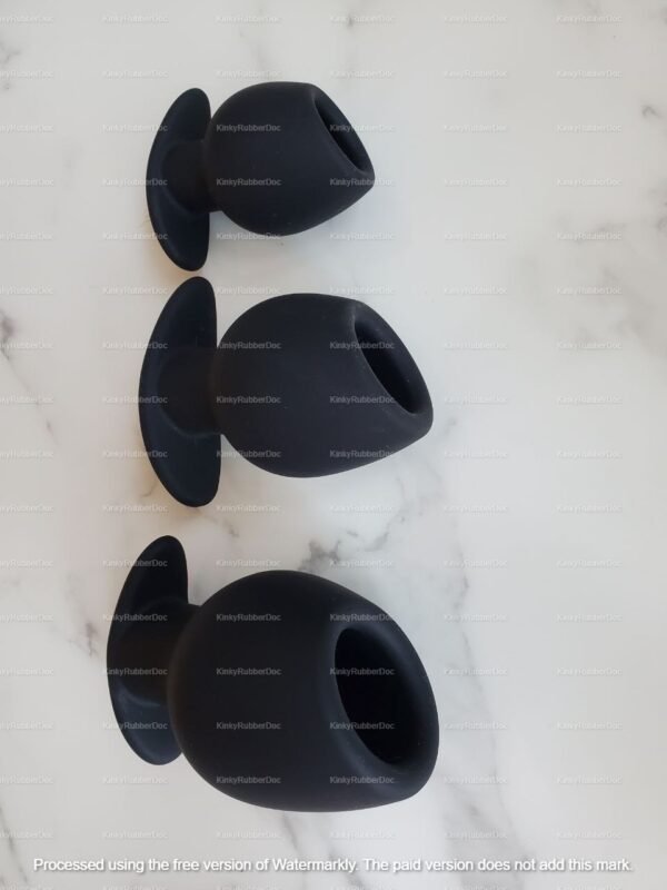 Set of three black hollow silicone butt plugs in varying sizes.