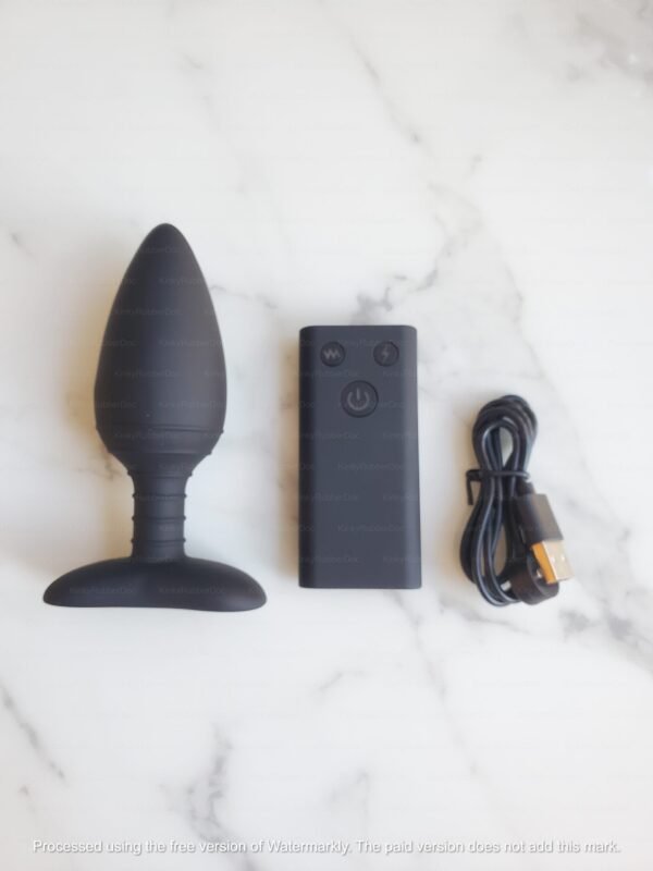Black Electroshock Vibrating Anal Plug with Remotel, and USB charging cable on marble surface