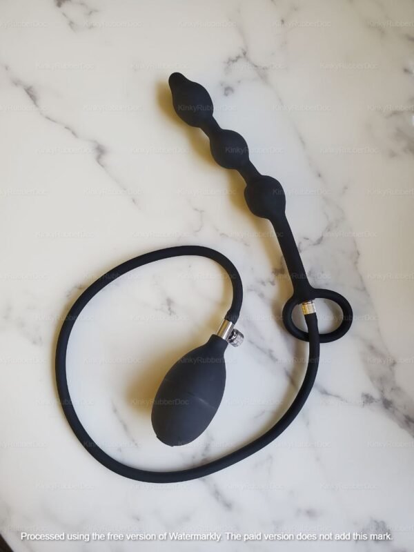 Inflatable Beads with Cock Ring with built-in cock ring and removable hand pump, placed on marble surface