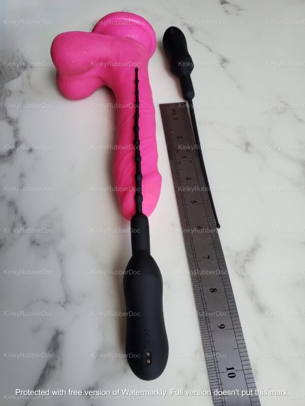 Black beaded vibrating urethral wand with silicone texture next to a size reference ruler.