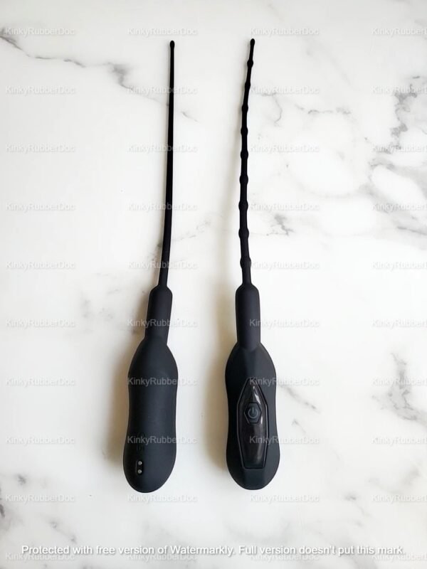 Black silicone vibrating urethral wands with smooth and beaded textures on a marble surface.