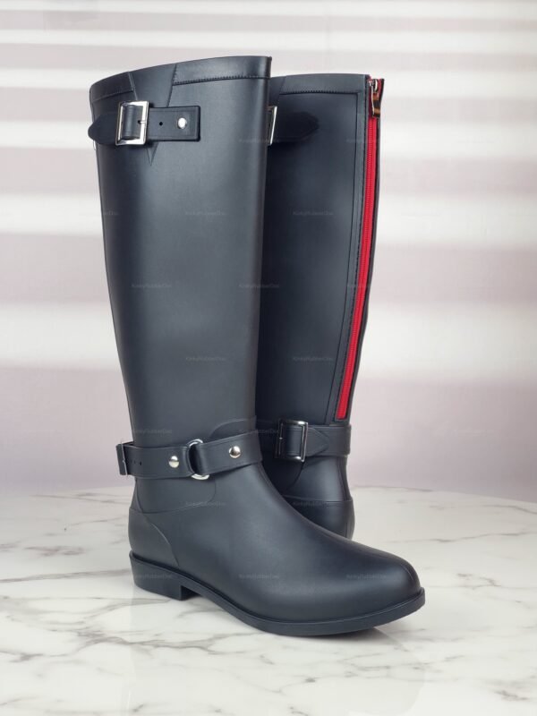Sleek black boots with red accents and silver buckle details for a bold, edgy look.