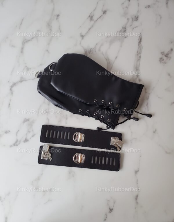 Sleek black cuffs and mitts set with lacing and metal hardware on a marble surface.