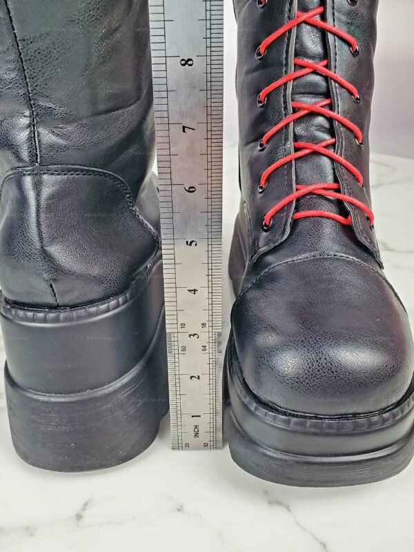 Black high boots with striking red laces and chunky platform soles.