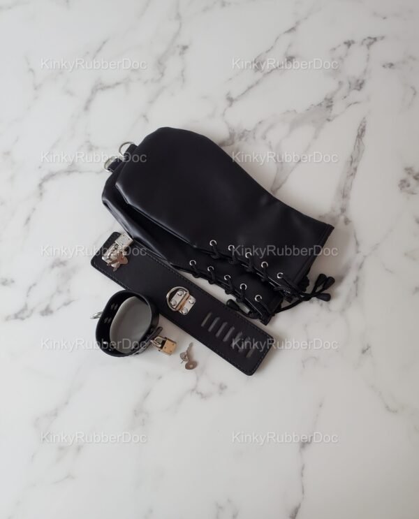 Black leather mitts with lace-up details, paired with a sleek cuff and padlock set on a marble surface.