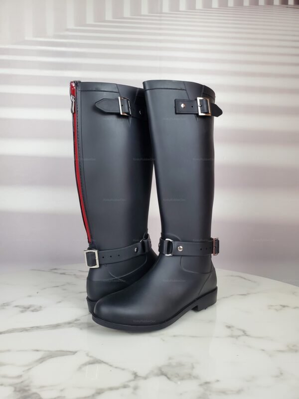 Sleek black rubber boots with red zipper and buckle details, ideal for cosplay and fetish fashion.