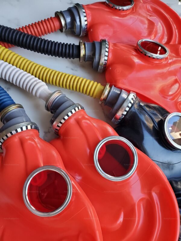 Vibrant red and black rubber gas masks with colorful hoses for fetish roleplay.