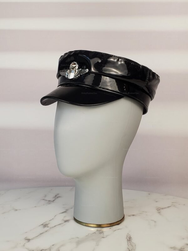 Shiny black fetish cap with peaked visor and metallic emblem.