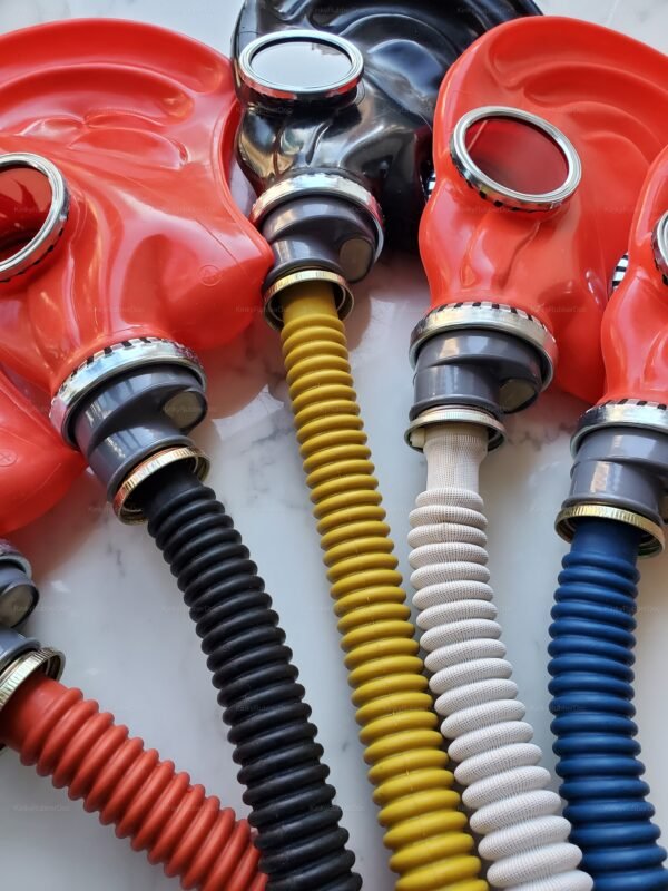 Vibrant rubber gas masks with colorful ribbed hoses in red, black, yellow, and white, designed for cosplay and roleplay.