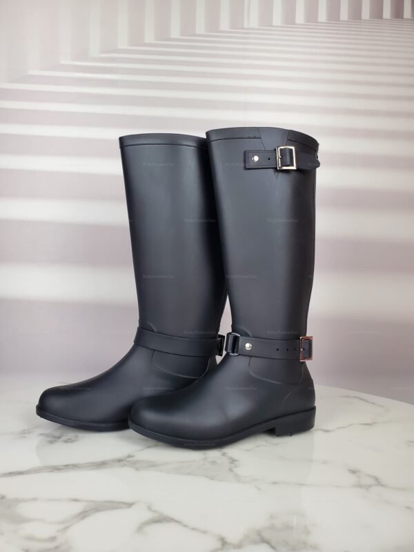 Sleek black rubber boots with a bold red back stripe and adjustable buckle accents.