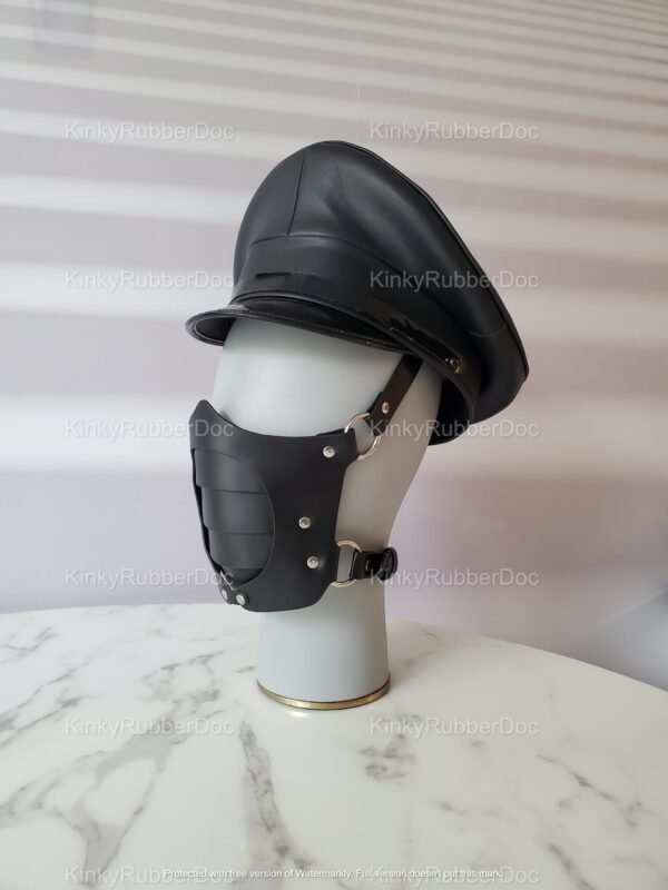 Black leather cap with matching leather face mask featuring metal studs and adjustable straps.