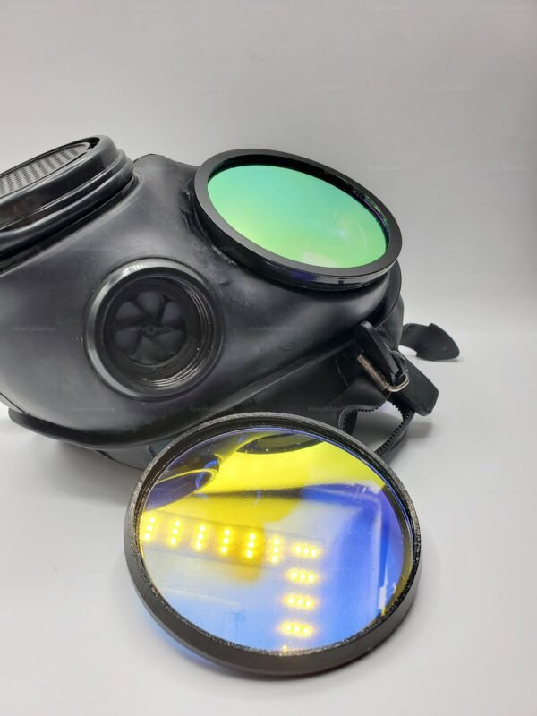 A black gas mask with vibrant rainbow reflective lenses, featuring a sleek design and adjustable straps.