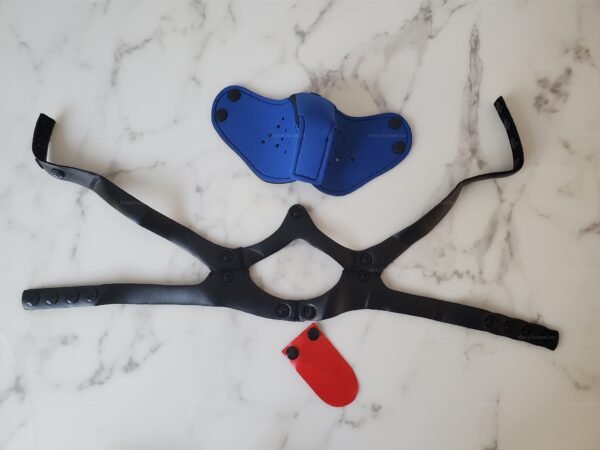 Neoprene pup muzzle with black straps, blue face piece, and red tongue attachment for pet play.