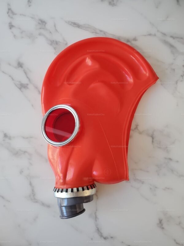 Red rubber gas mask with glossy finish, featuring a circular eye piece and a sturdy breathing attachment.