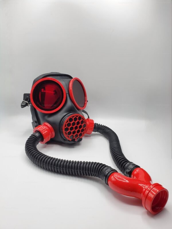 Futuristic red and black gas mask with flexible tubing and striking design.