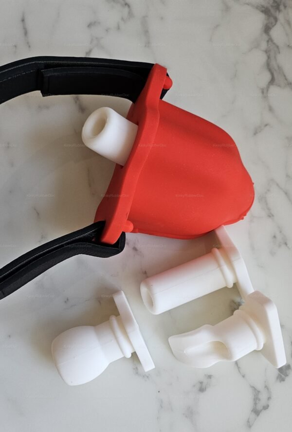 Red rubber funnel with interchangeable white attachments for adult fetish play.