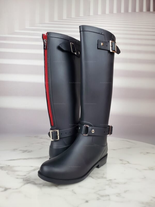 Sleek black rubber boots with red zipper and buckle accents.