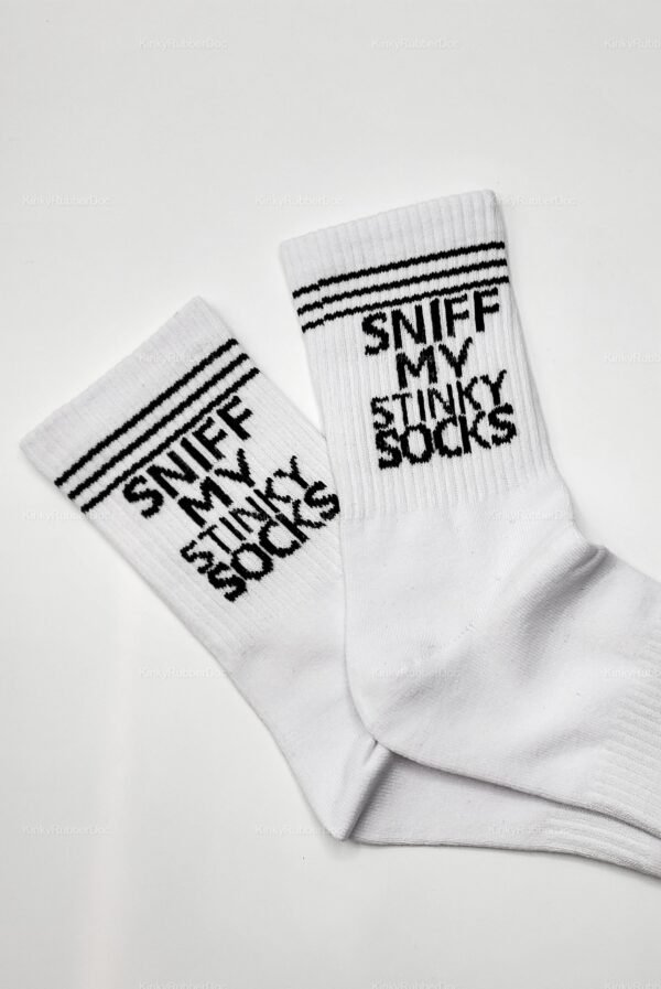 Pair of white socks with black stripes and bold embroidered text “SNIFF MY STINKY SOCKS” laid flat on white background