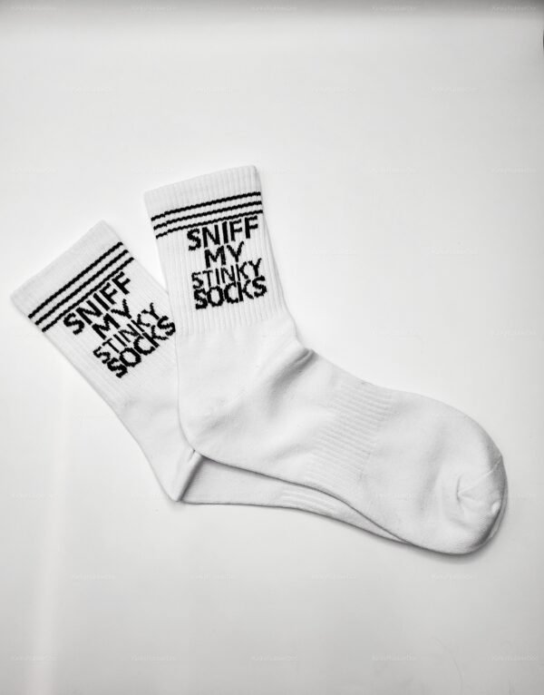Close-up of white socks with black text “SNIFF MY STINKY SOCKS” and black double stripe detail