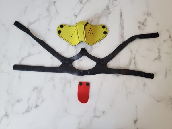 Bold yellow neoprene muzzle with adjustable black straps and a red accent piece for a playful and daring look.