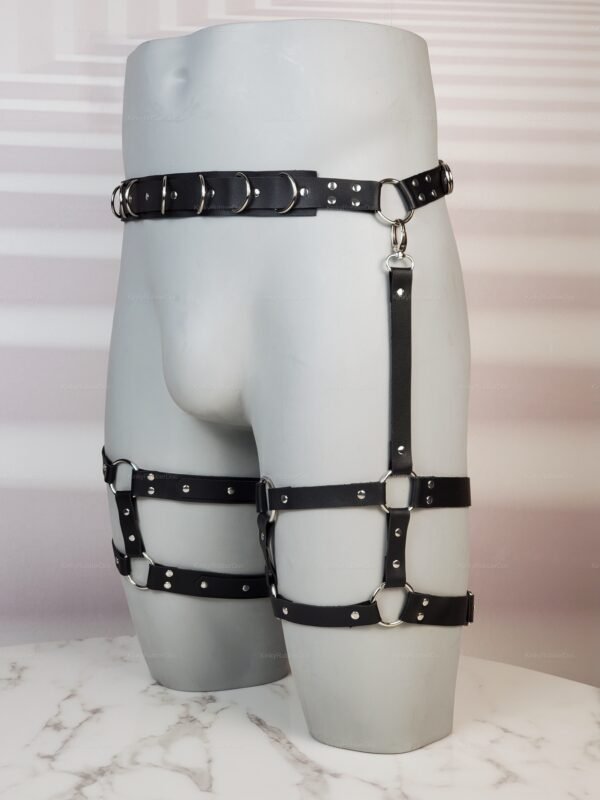 Adjustable black faux leather harness with silver rings and buckles.