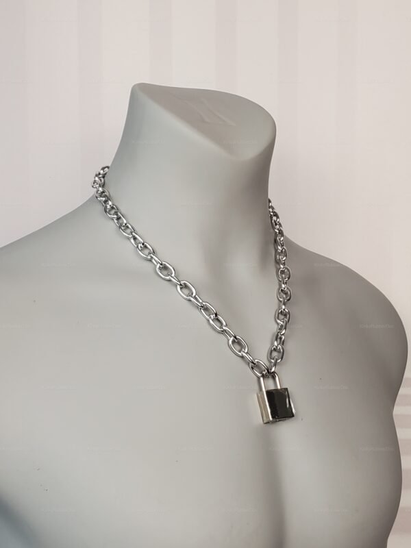 Front view of silver chain collar with metal padlock, worn on mannequin torso.