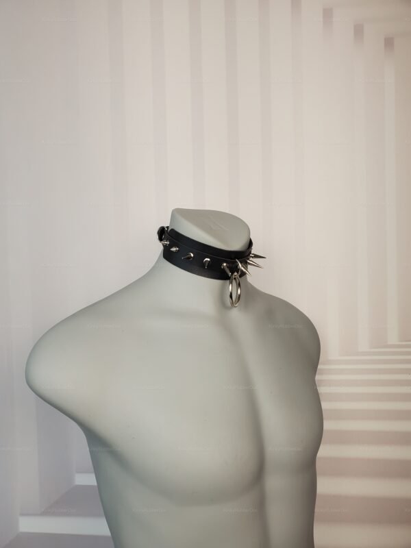 Black leather spiked collar with adjustable back buckle and metal ring.