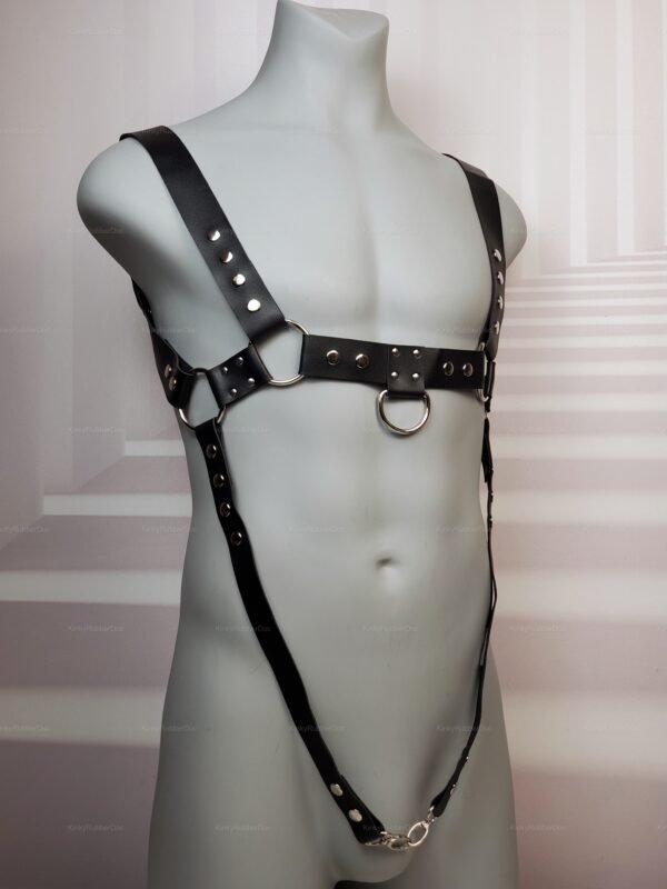 Black adjustable strap harness with D-ring details, designed for adult fashion and fetish wear.