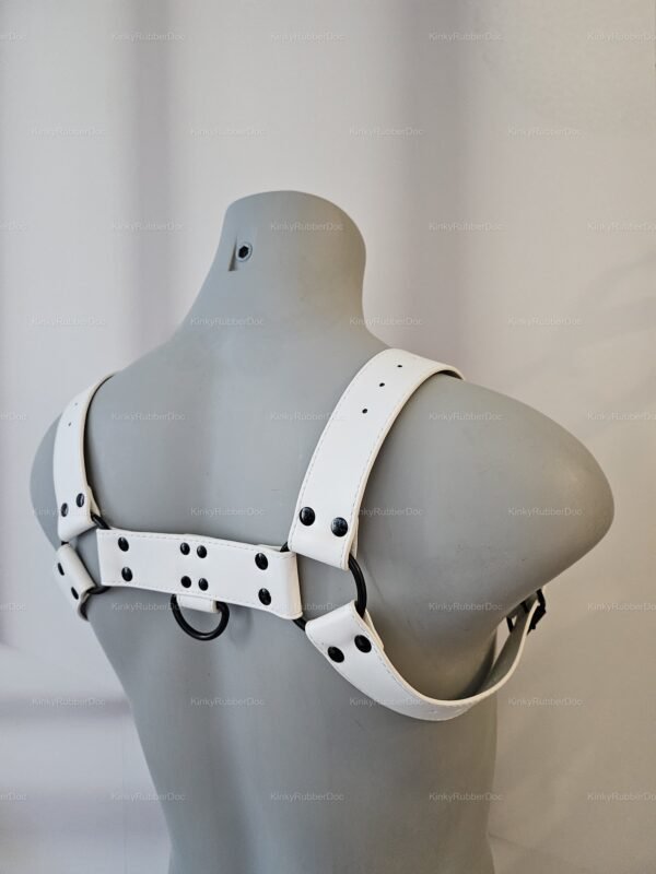 Close-up of an adjustable white PU leather harness with black metal accents.
