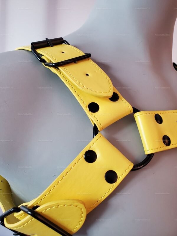 **Alt Text**: Back view of an adjustable yellow PU leather harness with black hardware.