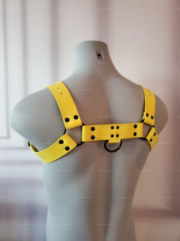 Bold yellow faux leather harness with black rivet detailing.