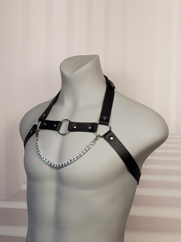 Black faux leather chest harness with metal chain detail.
