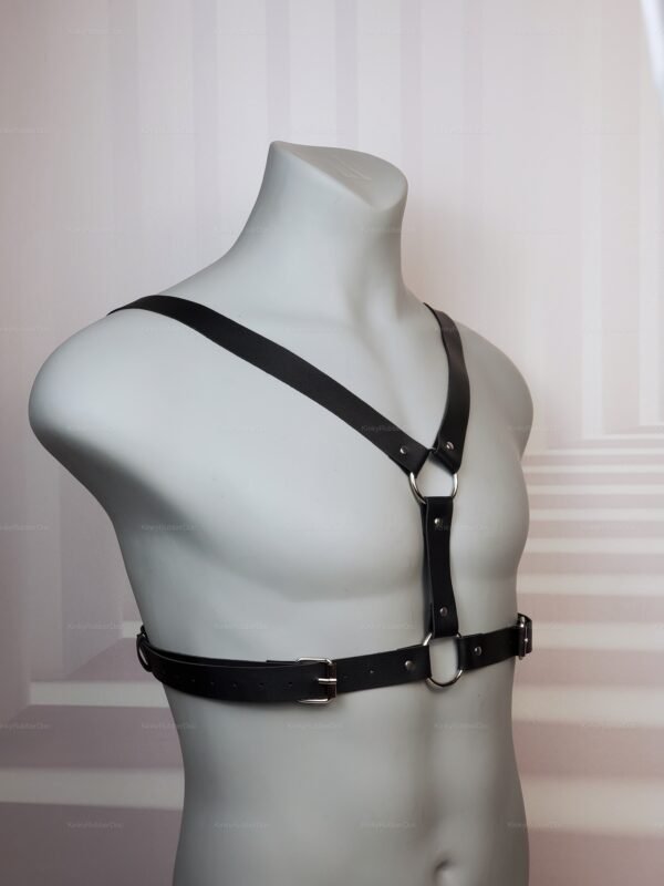 Black faux leather chest strap harness with O-rings, front view on mannequin