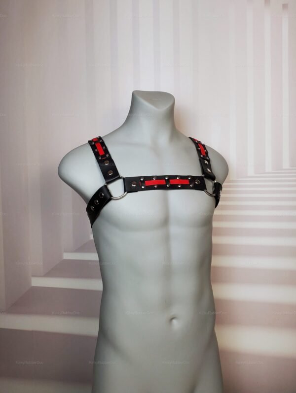 Faux-leather black and red harness with metal accents, front view.