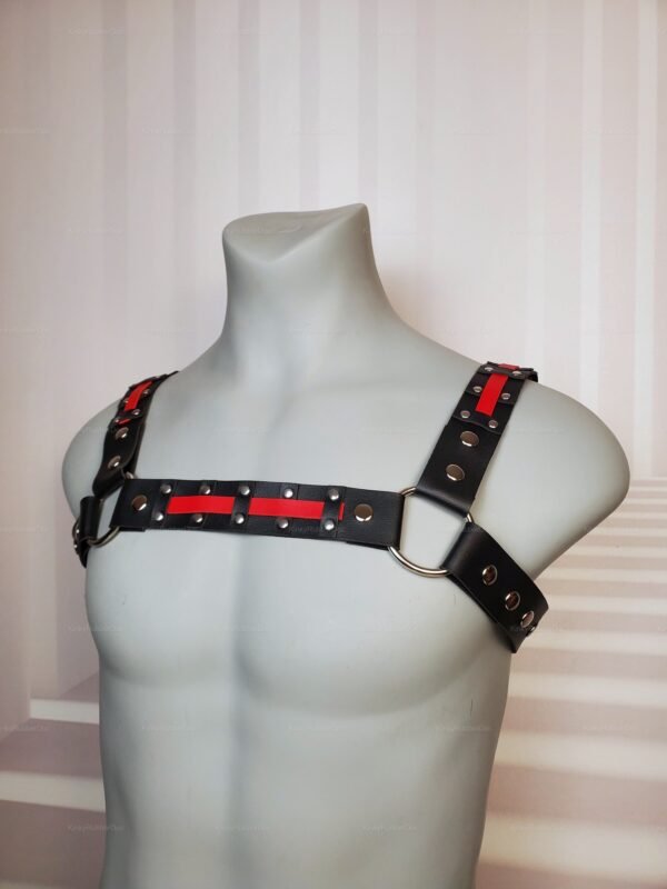 Red Black Chest Harness with red accent straps and silver snap details, displayed on mannequin torso.