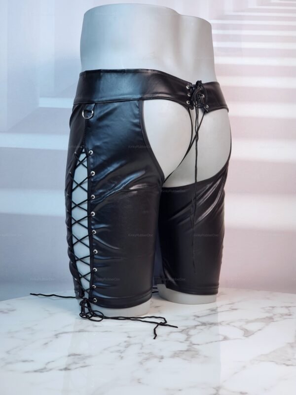 Faux leather lace-up shorts with side lacing and open back design on a marble surface.