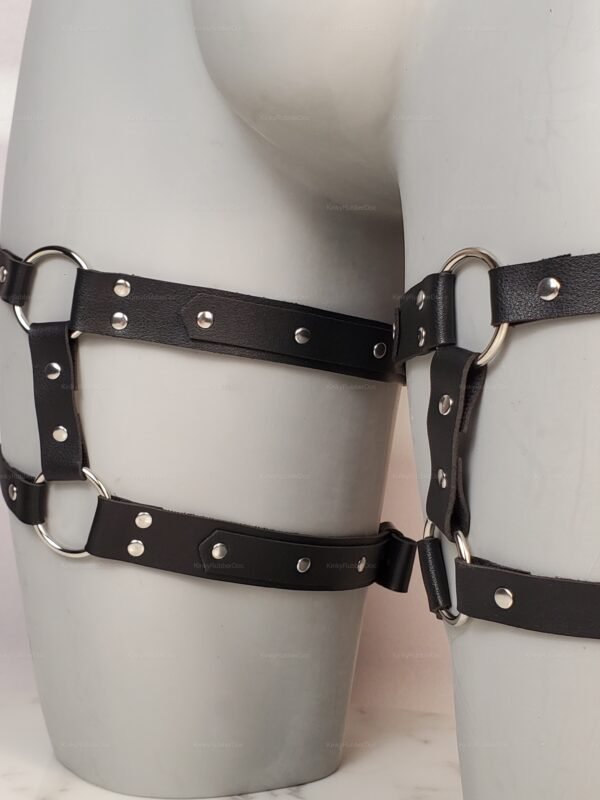 Black faux leather thigh harness with O-rings and adjustable straps, queer kink gear