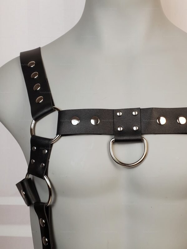 Black leather harness with metal rings and studs for a bold, edgy look.