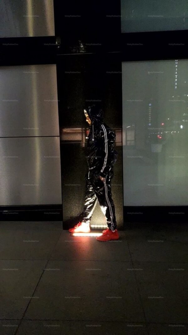 Shiny black PVC tracksuit with white stripes, exuding a bold and edgy vibe.