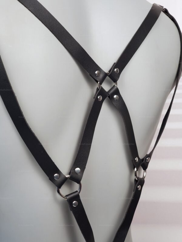 Stylish faux leather harness with silver metal accents, designed for a bold and adventurous look.