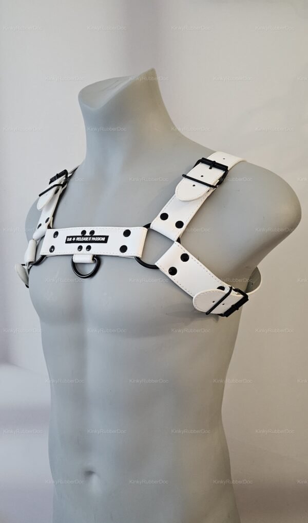 White harness with black rings and buckles, featuring bold text accents.