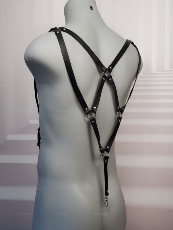 Black leather strap harness with metal rings and rivets in a gothic punk style.