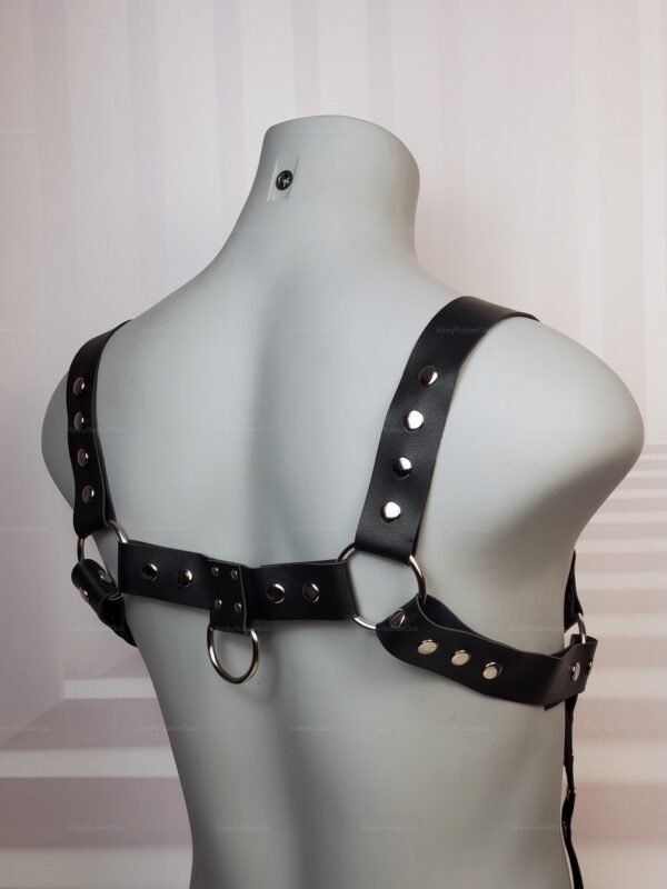 Back view of black leather suspenders with metal rivets and rings.
